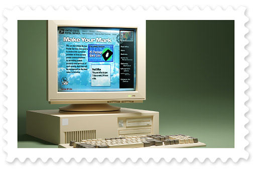 A colorful photograph of a desktop computer from the 1990s with a browser window displaying a USPS website.