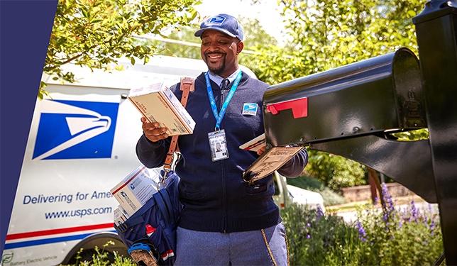 USPS mail truck with mail person outside of it delivering packages.